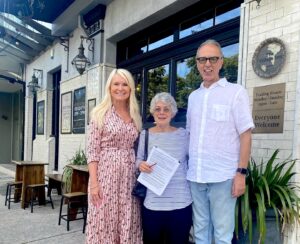 Harriet Price, Esther Hayer, Theo Onisforou outside the Village Inn